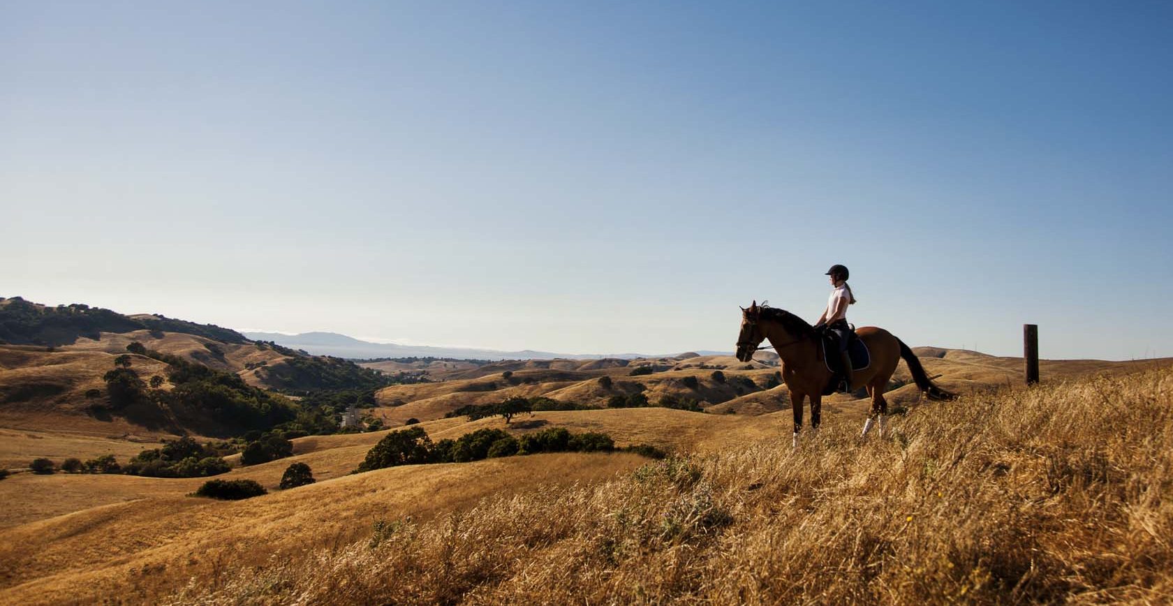 A woman on horseback explores the views of Sky Ranch