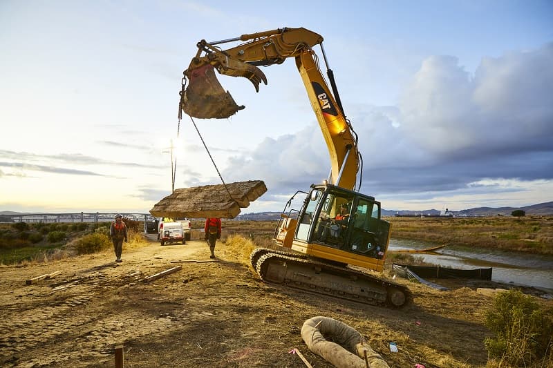 Heavy equipment working on marsh restoration project