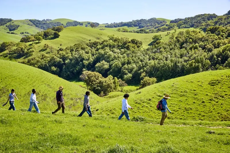 High School students hiking to restoration site